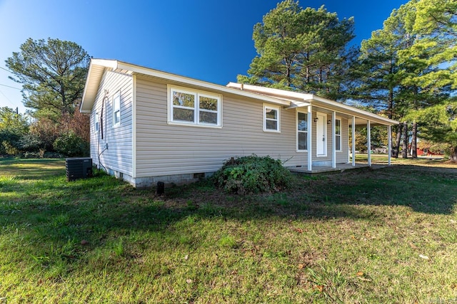 view of front of property with a front yard, cooling unit, and covered porch