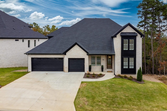 modern inspired farmhouse with a garage and a front yard