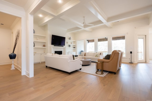 living room featuring light hardwood / wood-style flooring, beamed ceiling, ceiling fan, and coffered ceiling