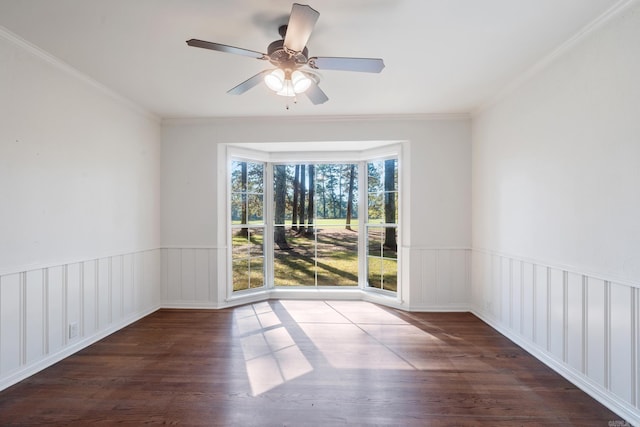 unfurnished room featuring ceiling fan, dark hardwood / wood-style floors, and ornamental molding