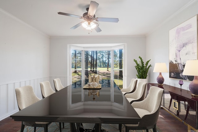 dining room with dark hardwood / wood-style flooring, ceiling fan, and crown molding