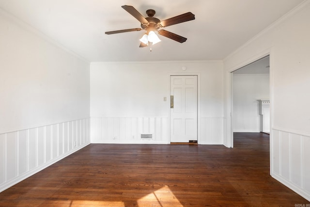 spare room with dark wood-type flooring, ceiling fan, and ornamental molding