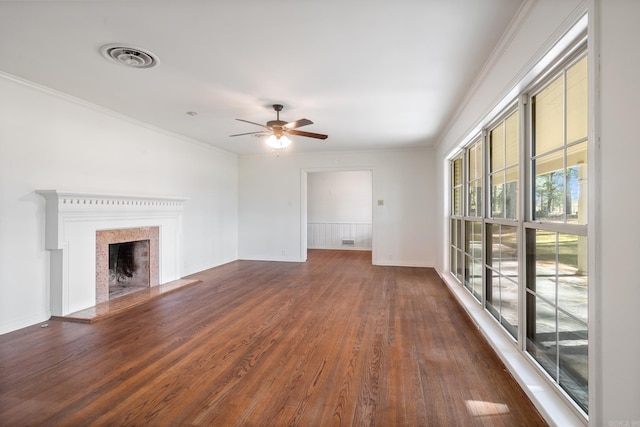 unfurnished living room featuring dark hardwood / wood-style flooring, ceiling fan, and crown molding