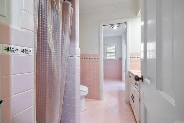 bathroom with toilet, vanity, tile walls, and a shower with shower curtain