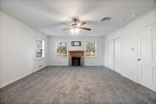 unfurnished living room with ceiling fan, carpet, ornamental molding, and a brick fireplace