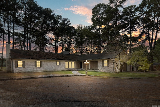 ranch-style house featuring a yard