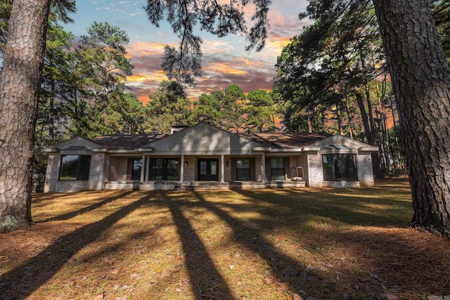 ranch-style home with a lawn