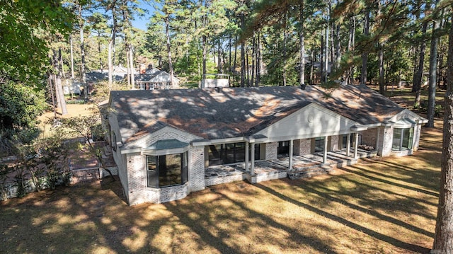 view of front facade featuring a front lawn and a patio