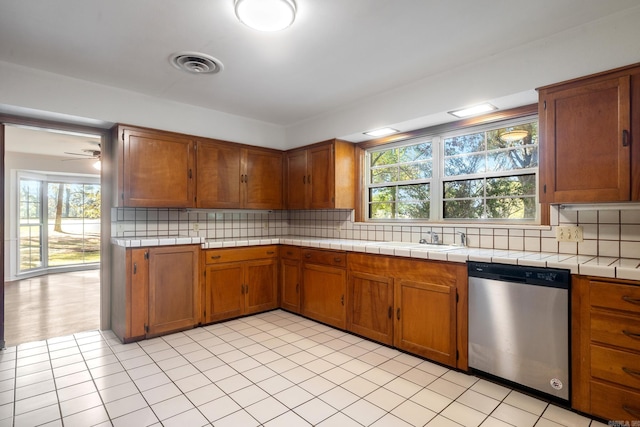 kitchen featuring plenty of natural light, sink, decorative backsplash, and dishwasher