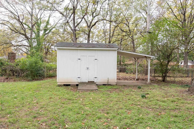 view of outbuilding featuring a lawn