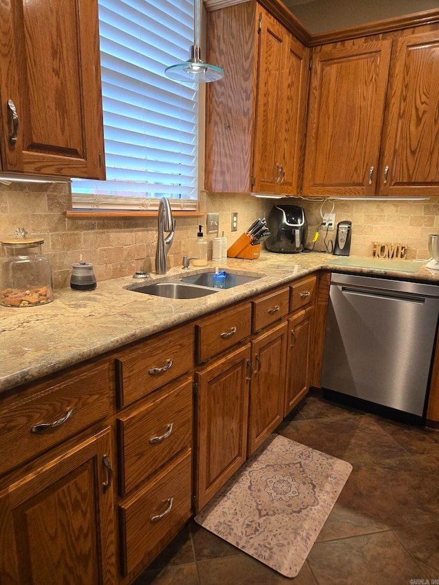 kitchen with decorative backsplash, sink, stainless steel dishwasher, and dark tile patterned flooring