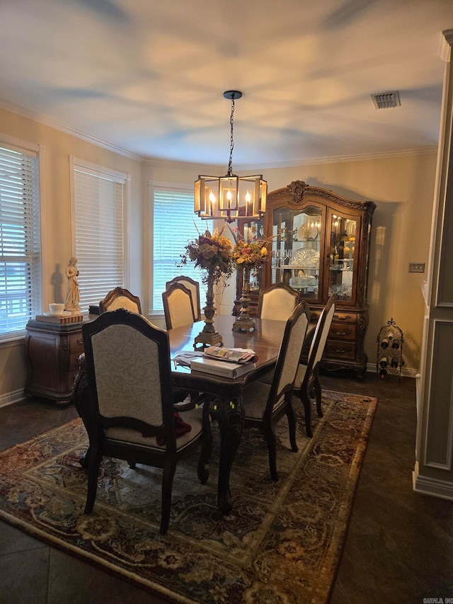 dining space featuring crown molding and an inviting chandelier