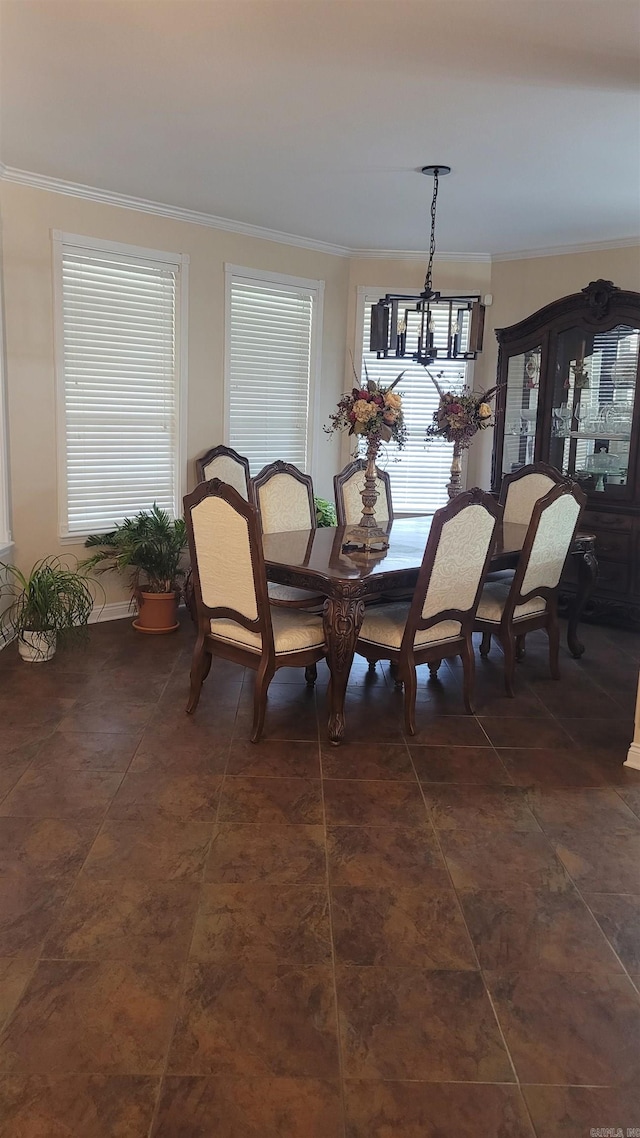 dining area with crown molding and a notable chandelier