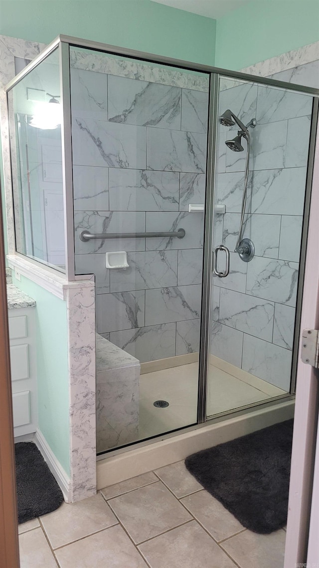 bathroom with tile patterned flooring and an enclosed shower