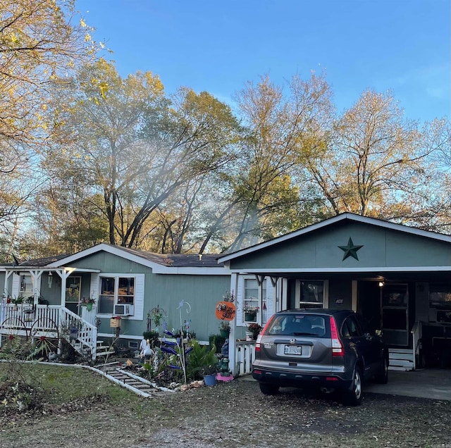 view of front of home with a carport and a porch