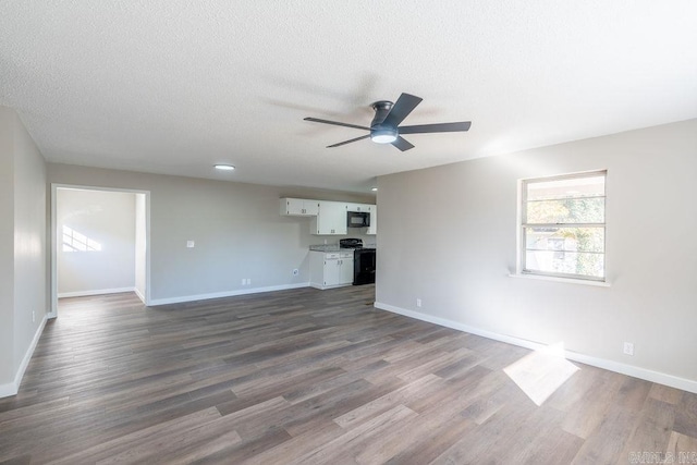 unfurnished living room featuring ceiling fan, a textured ceiling, and dark hardwood / wood-style floors