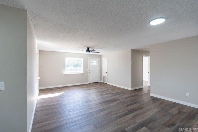 interior space with dark wood-type flooring, ceiling fan, and a textured ceiling