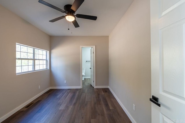 spare room with dark hardwood / wood-style flooring and ceiling fan