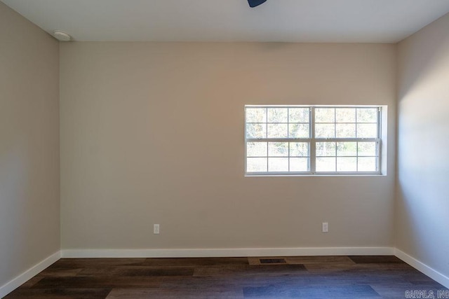 empty room featuring dark wood-type flooring