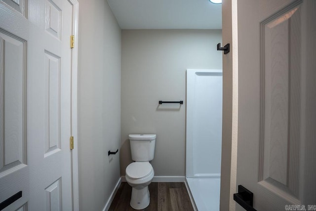 bathroom with toilet and hardwood / wood-style flooring