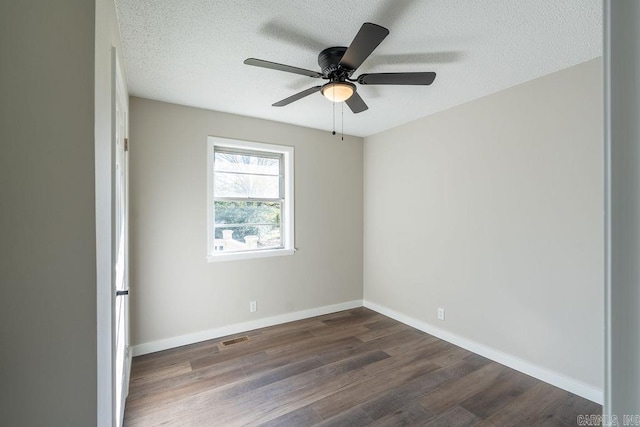 unfurnished room featuring ceiling fan, a textured ceiling, and dark hardwood / wood-style floors