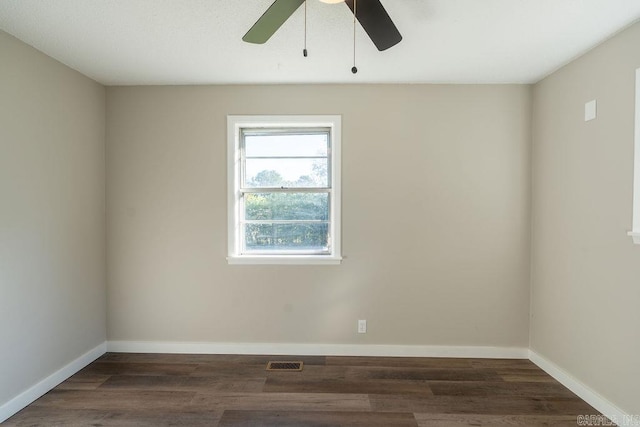 spare room featuring dark hardwood / wood-style flooring and ceiling fan