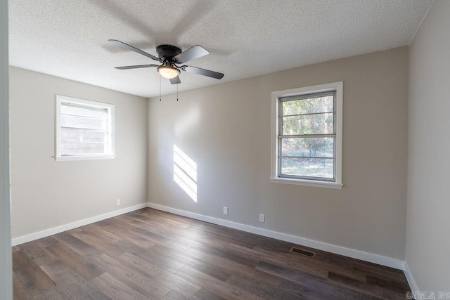 unfurnished room featuring dark wood-type flooring, a textured ceiling, and ceiling fan