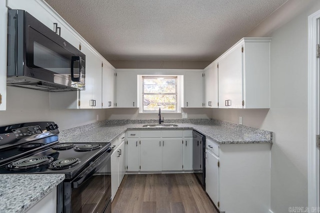 kitchen with black appliances, a textured ceiling, sink, white cabinets, and light hardwood / wood-style flooring