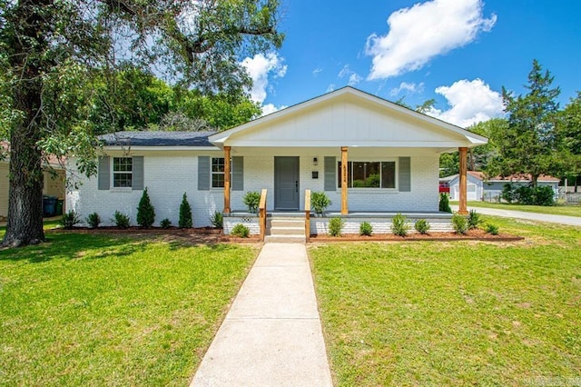 view of front of house with a porch and a front lawn