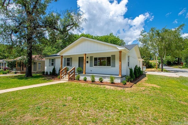 ranch-style house with a front lawn and covered porch