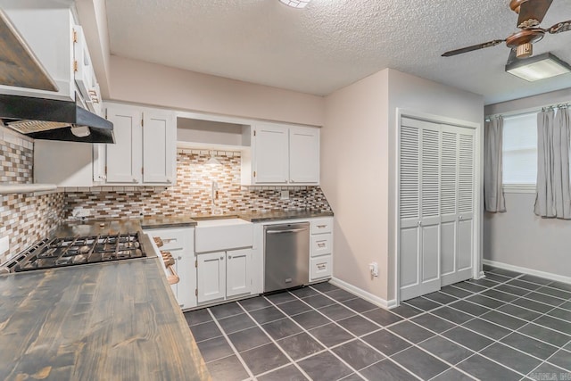 kitchen with stainless steel appliances, decorative backsplash, sink, ceiling fan, and white cabinetry