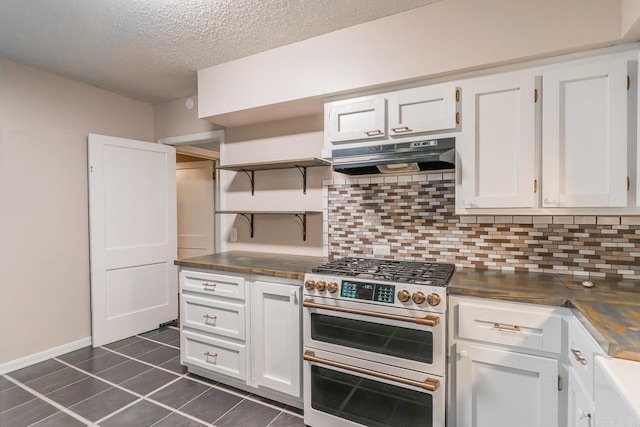 kitchen with white cabinets, range with two ovens, and decorative backsplash