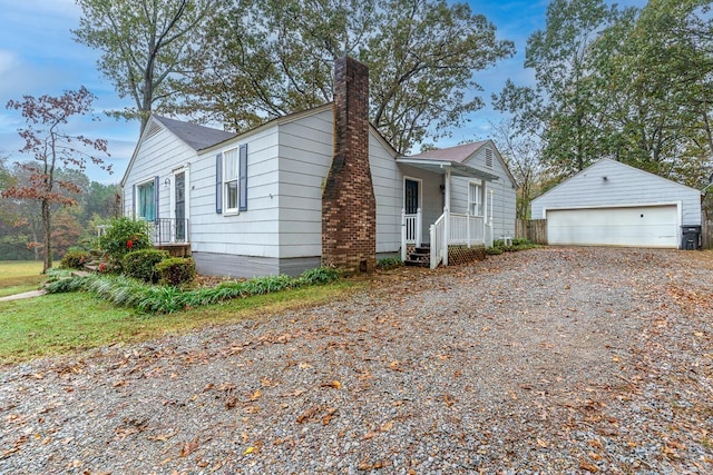 view of front of home featuring a garage and an outbuilding