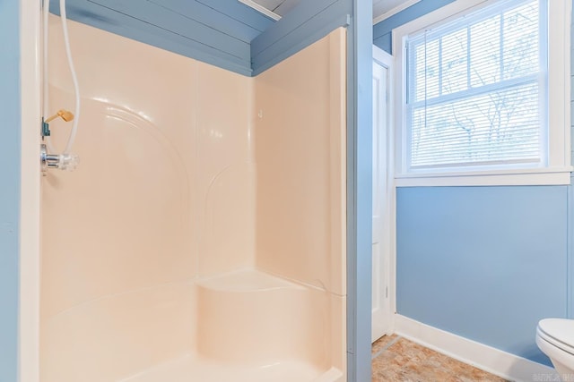 bathroom with a shower and toilet