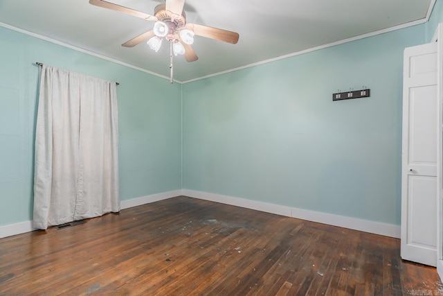 spare room featuring dark wood-type flooring, ceiling fan, and ornamental molding