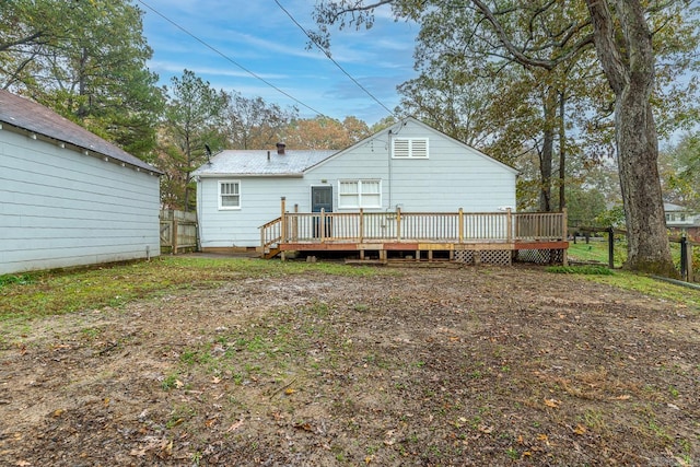 rear view of house featuring a wooden deck