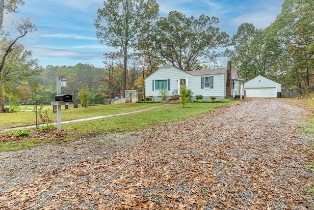 ranch-style house with an outbuilding, a garage, and a front lawn