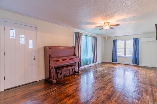 entrance foyer with ceiling fan, dark hardwood / wood-style floors, and a textured ceiling