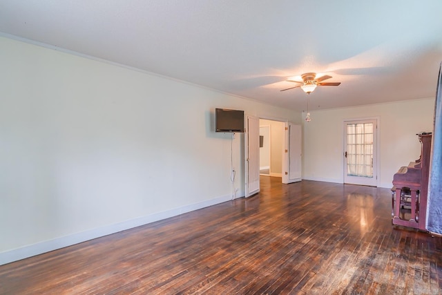 unfurnished living room with dark wood-type flooring, ceiling fan, and ornamental molding