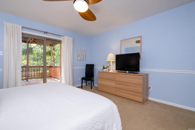 carpeted bedroom with a textured ceiling, ceiling fan, and access to exterior