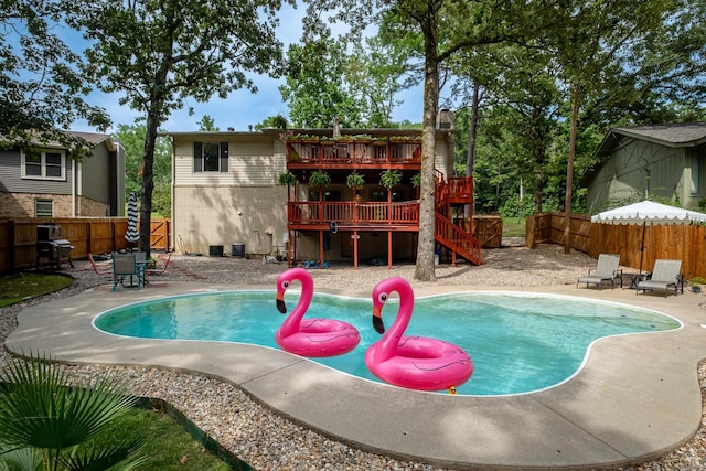 view of pool featuring a wooden deck and a patio