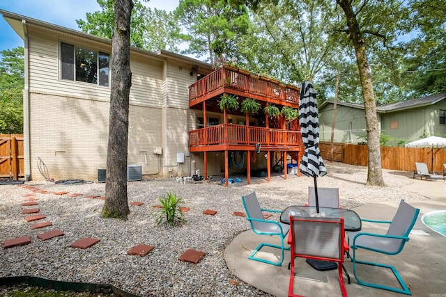 rear view of house featuring a patio area and a wooden deck