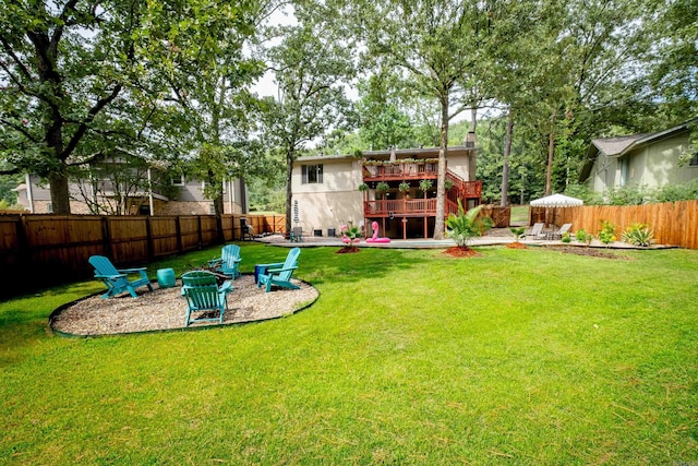 view of yard featuring a patio area, an outdoor fire pit, and a deck