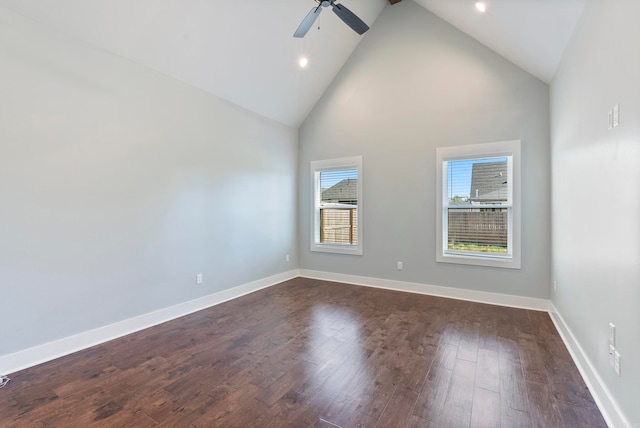 empty room featuring high vaulted ceiling, dark wood-type flooring, and ceiling fan