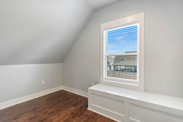 additional living space featuring dark hardwood / wood-style floors and vaulted ceiling