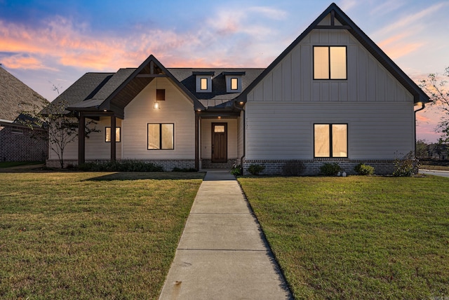 modern farmhouse style home with a yard