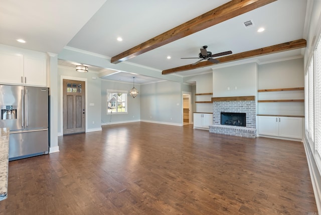 unfurnished living room featuring a fireplace, beam ceiling, dark hardwood / wood-style flooring, and crown molding