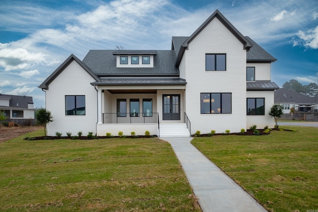 view of front of property with covered porch and a front yard