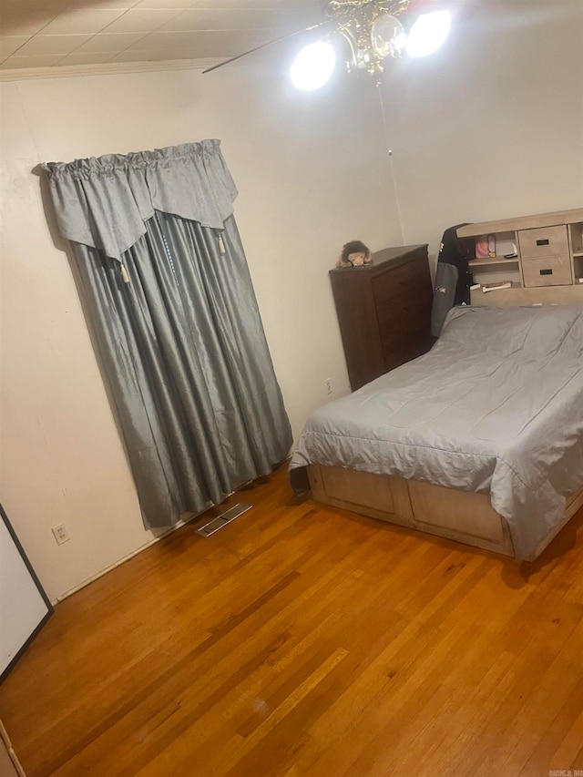 bedroom with ceiling fan and hardwood / wood-style flooring