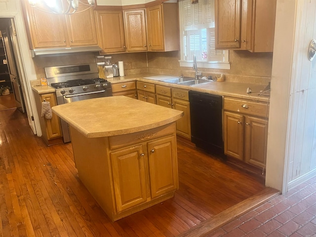 kitchen with gas range, dark wood-type flooring, sink, black dishwasher, and a kitchen island